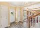 Inviting foyer features wood flooring, view to dining area, and a decorative front door at 105 Pine Valley Ct, Hiram, GA 30141