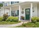 Charming home featuring a welcoming front porch with swing and landscaped garden at 105 Pine Valley Ct, Hiram, GA 30141
