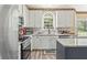 Well-lit kitchen with stainless steel appliances, granite countertops, and a large sink at 105 Pine Valley Ct, Hiram, GA 30141