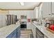 Well-equipped kitchen features stainless steel appliances and granite countertops at 105 Pine Valley Ct, Hiram, GA 30141