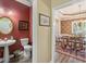 Stylish half bath featuring a pedestal sink, mirror, and decorative accents at 105 Pine Valley Ct, Hiram, GA 30141
