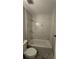 Bathroom features tub-shower combo with white marble tiling and a modern toilet at 15 Harlan Rd, Atlanta, GA 30311