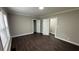 Neutral bedroom with wood floors, ample natural light, and two closets for storage at 15 Harlan Rd, Atlanta, GA 30311