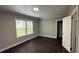 Cozy bedroom with wood floors, closet, and bright windows offering ample natural light at 15 Harlan Rd, Atlanta, GA 30311
