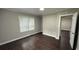 View of a bedroom with two windows and dark, wood-look flooring at 15 Harlan Rd, Atlanta, GA 30311