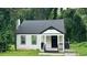 Charming house features a gray roof, white siding, black trim, and a cozy front porch at 15 Harlan Rd, Atlanta, GA 30311