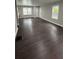 Spacious living room featuring dark wood floors and neutral walls with an entry and large windows at 15 Harlan Rd, Atlanta, GA 30311