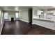 Open-concept living area with wood floors, fireplace, and a modern kitchen with white cabinets at 15 Harlan Rd, Atlanta, GA 30311