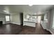 Open-concept living area with wood floors connecting the living room to the kitchen at 15 Harlan Rd, Atlanta, GA 30311
