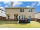 Back exterior showing a brick and siding home with a grassy yard and patio at 316 Sierra Ct, Mcdonough, GA 30253