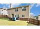 Back exterior showing a brick and siding home with a grassy yard and patio at 316 Sierra Ct, Mcdonough, GA 30253