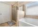 Bright bathroom featuring a separate tub and shower with tile surround at 316 Sierra Ct, Mcdonough, GA 30253