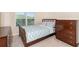 Bedroom with a window, dresser, and a bed with striped blue and white patterned bedding at 316 Sierra Ct, Mcdonough, GA 30253