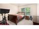 Cozy bedroom with neutral walls, a large window for natural light, and carpet flooring at 316 Sierra Ct, Mcdonough, GA 30253