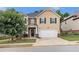 Charming two-story home featuring a two-car garage and well-manicured front lawn at 316 Sierra Ct, Mcdonough, GA 30253