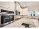Bright, modern kitchen featuring white cabinets, granite countertops and stainless steel appliances at 316 Sierra Ct, Mcdonough, GA 30253