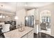 Open-concept kitchen with stainless appliances flowing into a dining and living space at 316 Sierra Ct, Mcdonough, GA 30253