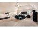 Spacious primary bedroom features vaulted ceilings, fan, and dark furniture at 316 Sierra Ct, Mcdonough, GA 30253