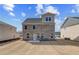 Backyard view of a new two-story brick home with a concrete patio and spacious lawn at 619 Leafy Branch Way, Mcdonough, GA 30253