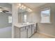Elegant bathroom with double sinks, large mirror, and a window for natural light at 619 Leafy Branch Way, Mcdonough, GA 30253