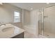 Modern bathroom featuring a double vanity, tub, and a glass-enclosed shower at 619 Leafy Branch Way, Mcdonough, GA 30253