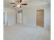 Cozy bedroom with neutral carpet, ceiling fan, and an open closet with wire shelving at 619 Leafy Branch Way, Mcdonough, GA 30253