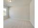 Spacious bedroom with neutral carpet and ample natural light from a large window at 619 Leafy Branch Way, Mcdonough, GA 30253