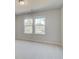 Bright and open bedroom with two large windows and neutral carpet at 619 Leafy Branch Way, Mcdonough, GA 30253