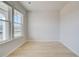 Sunlit room featuring hardwood floors and large windows for natural light and open feel at 619 Leafy Branch Way, Mcdonough, GA 30253
