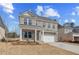 Comfortable two-story brick home featuring a two-car garage and a covered front porch at 619 Leafy Branch Way, Mcdonough, GA 30253
