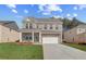 New two-story brick home with a two-car garage and manicured lawn at 619 Leafy Branch Way, Mcdonough, GA 30253