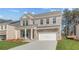 Attractive brick two-story home with a front porch, manicured lawn, and a two-car garage at 619 Leafy Branch Way, Mcdonough, GA 30253