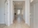Bright hallway with hardwood floors leading to a living area with a fireplace feature at 619 Leafy Branch Way, Mcdonough, GA 30253
