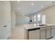 Kitchen island with quartz countertops, stainless steel dishwasher, and gray cabinetry at 619 Leafy Branch Way, Mcdonough, GA 30253
