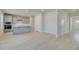Open-concept kitchen features shaker cabinets, stainless appliances, a central island, and durable light-colored floors at 619 Leafy Branch Way, Mcdonough, GA 30253