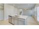 Kitchen island view shows stainless dishwasher, sink, ample storage, and connection to staircase at 619 Leafy Branch Way, Mcdonough, GA 30253