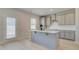 Modern kitchen featuring shaker cabinets, stainless appliances, a functional island, and convenient outdoor access at 619 Leafy Branch Way, Mcdonough, GA 30253