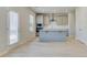 Stylish kitchen boasts shaker cabinets, stainless appliances, a central island, and easy access to the outdoors at 619 Leafy Branch Way, Mcdonough, GA 30253