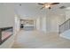 Open-concept space with hardwood floors, fireplace, kitchen and a staircase, for easy living at 619 Leafy Branch Way, Mcdonough, GA 30253