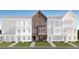 Exterior elevation of a brown brick townhouse with a well-manicured lawn at 813 Atkins Ln, Woodstock, GA 30188