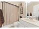 Neat bathroom featuring a shower with curtain, white sink, and classic fixtures for a clean aesthetic at 154 Hunters Trl, Dallas, GA 30157