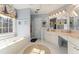 Bright bathroom with double vanity, soaking tub, and large window offering a serene view at 154 Hunters Trl, Dallas, GA 30157