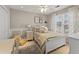 Cozy bedroom featuring a white frame bed, soft neutral tones and ample natural light from the large windows at 154 Hunters Trl, Dallas, GA 30157