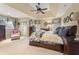 Spacious primary bedroom with tray ceilings, a seating area, and elegant furnishings for ultimate relaxation at 154 Hunters Trl, Dallas, GA 30157