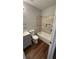 Modern bathroom with a shower-tub combo, neutral tile surround, and updated fixtures at 38 Royce Dr, Jonesboro, GA 30238
