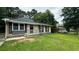 Charming single-story home featuring a brick facade, gray siding, and a well-maintained front lawn at 38 Royce Dr, Jonesboro, GA 30238