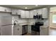Updated kitchen with stainless steel appliances, granite countertops, and new cabinets at 38 Royce Dr, Jonesboro, GA 30238