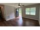 Cozy living room featuring hardwood floors, a modern ceiling fan, and lots of natural light at 38 Royce Dr, Jonesboro, GA 30238