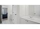 Bright bathroom with white tile floors and a double-sink vanity at 4320 Cody Ct, Cumming, GA 30040
