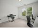 Bedroom area with a window view, black desk chairs, and standing keyboard at 4320 Cody Ct, Cumming, GA 30040